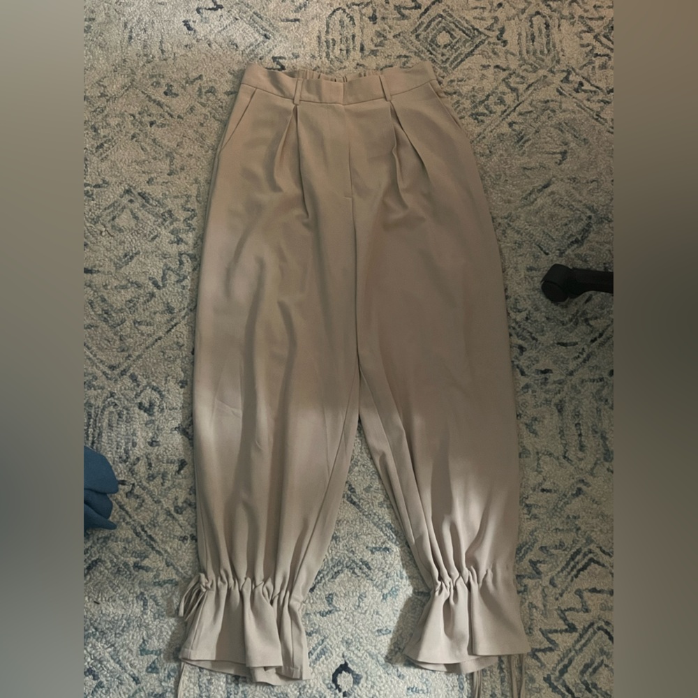 Light tan work pants with scrunch ankles and ties